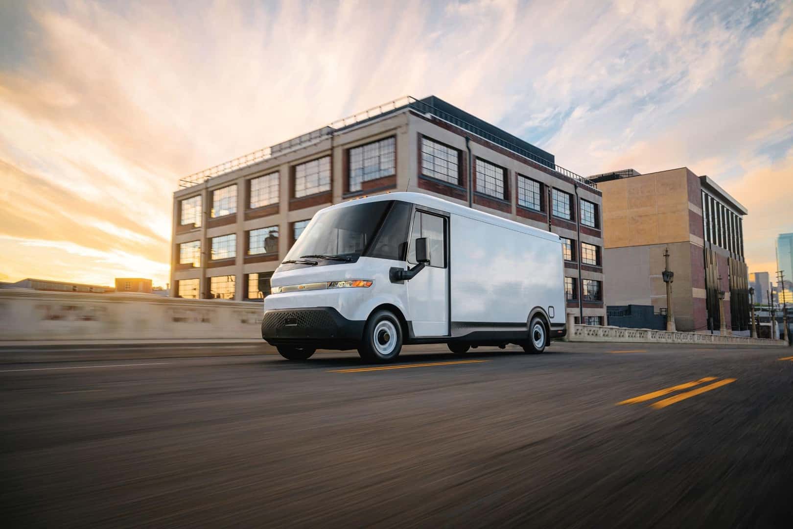 The Dependable And Powerful Chevrolet Brightdrop Driving Past A Business Building