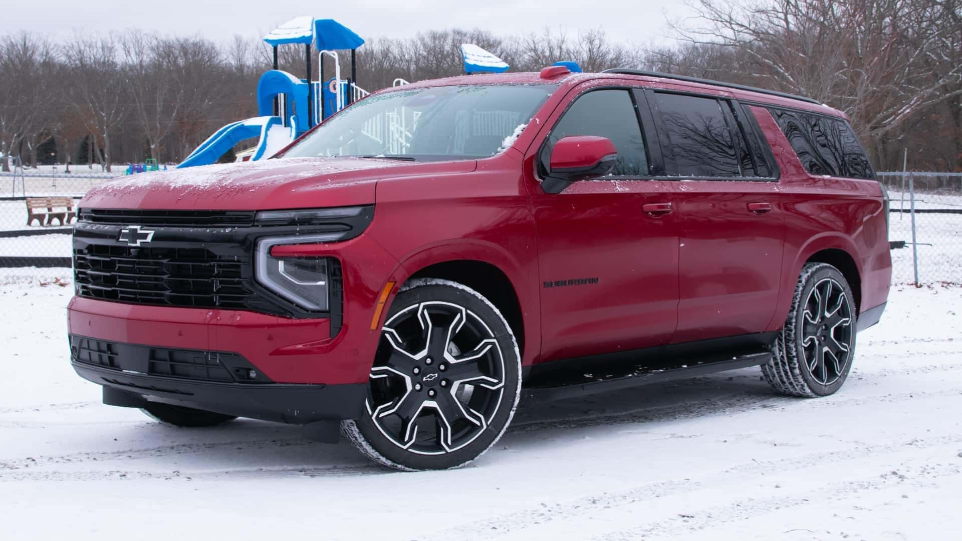 2025 Chevrolet Suburban RST red parked in snow