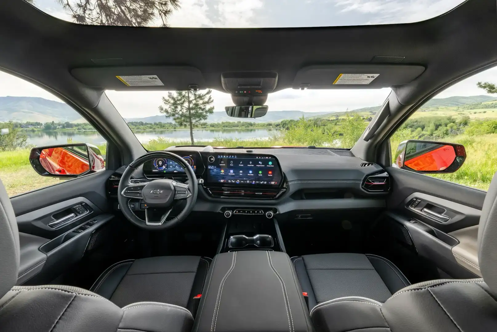 2026 Chevrolet Silverado Trail Boss interior looking from the back seat over the front seats and media console looking towards the mountains