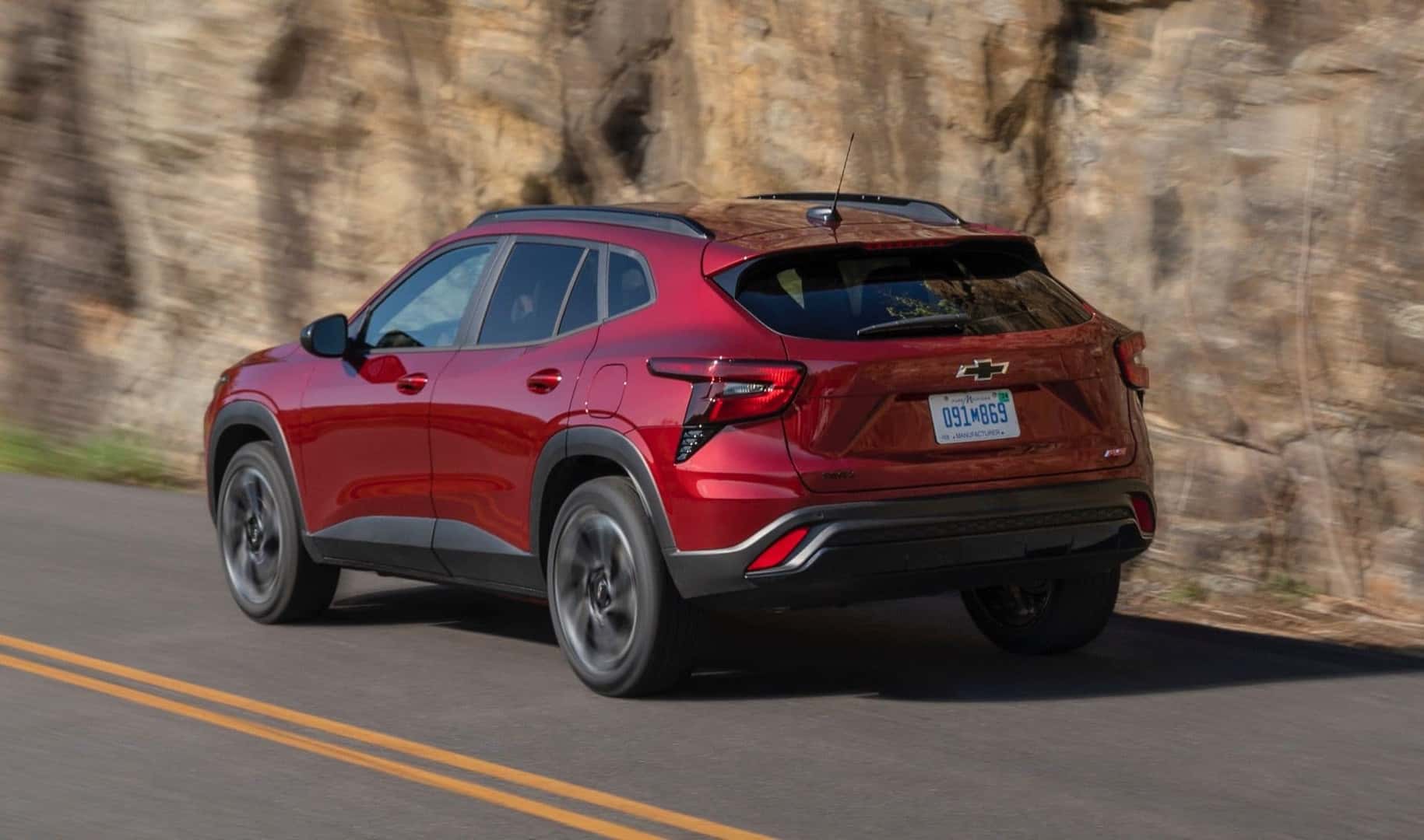 The Sporty And Stylish Chevrolet Trax, Cruising On A Highway Near A Rocky Cliff