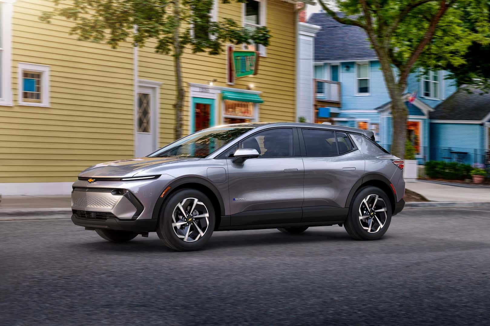 The Versatile And Affordable 2026 Chevrolet Equinox EV, Parked Near a Yellow And A Blue Building