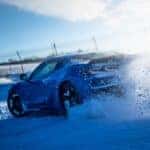 The Epic And Fuel-Efficient 2026 Chevrolet Corvette E-Ray Making A Turn And Blowing Off Snow From The Glittering Snow-Covered Ground